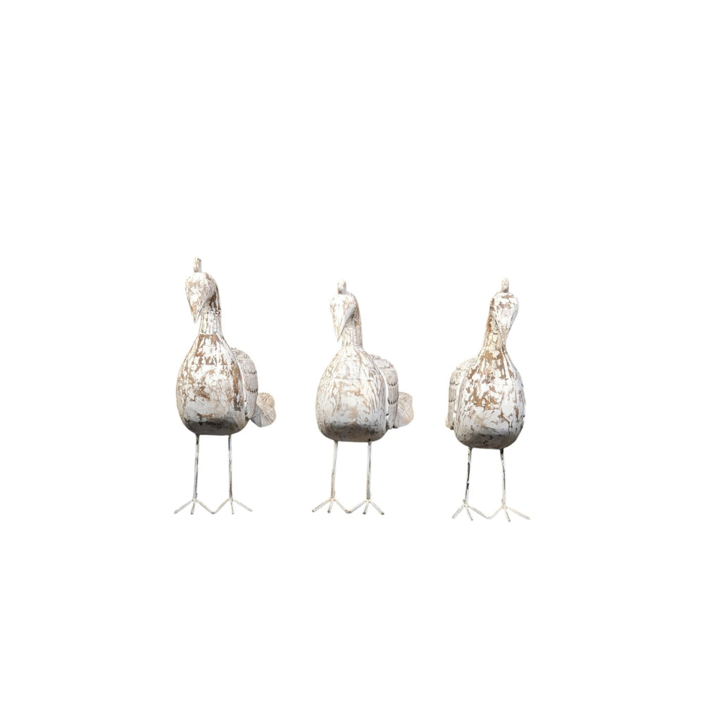Three decorative bird figures on stand against a white background