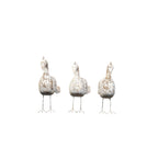 Three decorative bird figures on stand against a white background