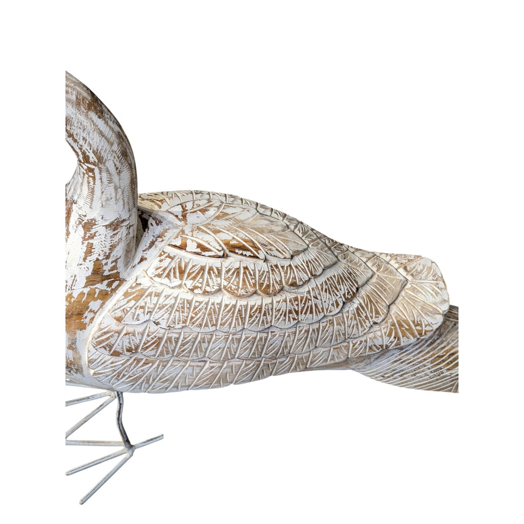 Decorative bird sculpture with intricate patterns on a white background