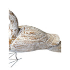 Decorative bird sculpture with intricate patterns on a white background
